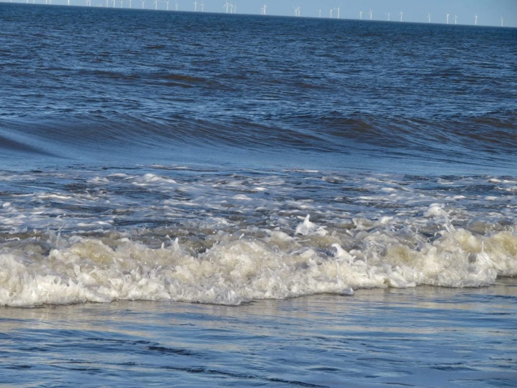 blue sea with wave crashing